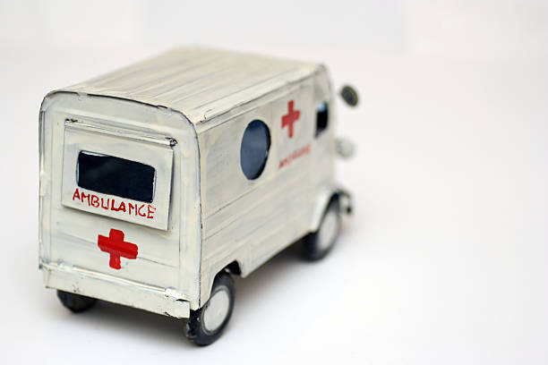 Hand painted metal model of an old fashioned ambulance. Viewed from behind. 