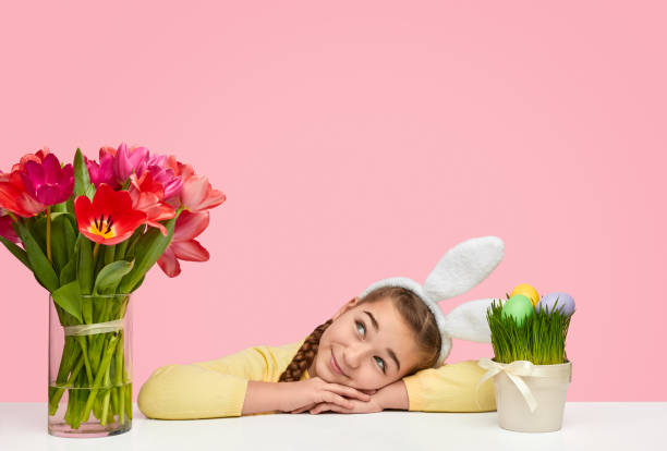 istock Cute girl with flowers and Easter eggs 1155391613