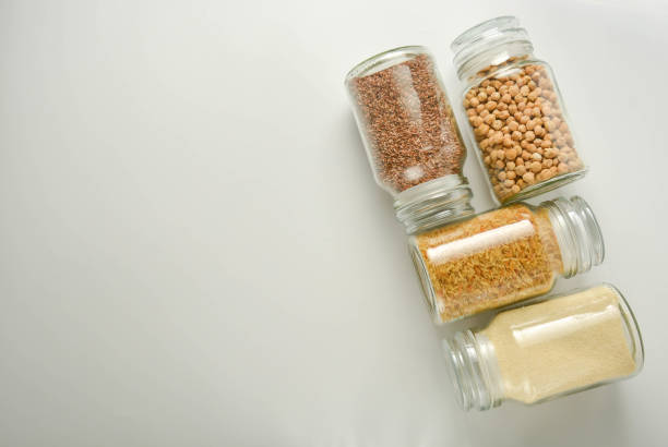 istock Various raw cereals in glass jar. Zero waste concept. Food storage. Flat lay. White background. 1155392194