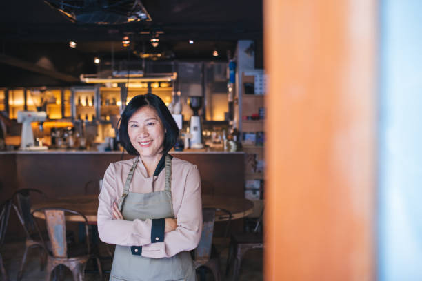 istock Senior Cafe owner standing with crossed arms 1155392204