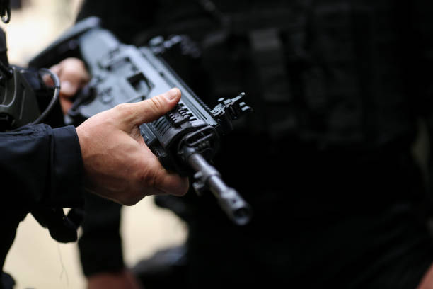 istock Details with the hands of a man holding an automatic rifle 1155392255
