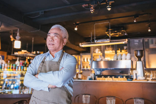 istock Senior Cafe owner standing with crossed arms 1155393033