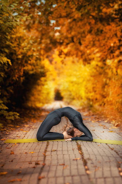 istock beautiful girl doing yoga in the fall 1155395122