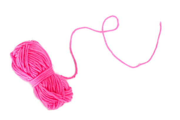 istock yarn color pink on white background. 1155395298