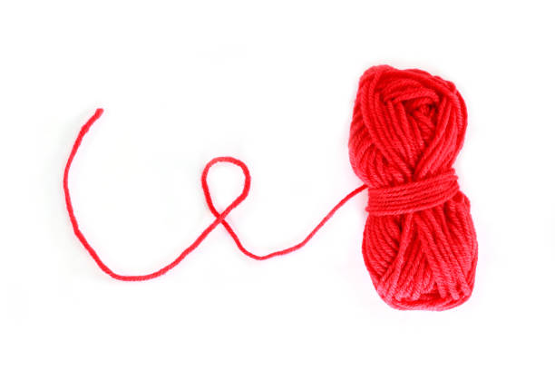 istock yarn color red on white background. 1155395312