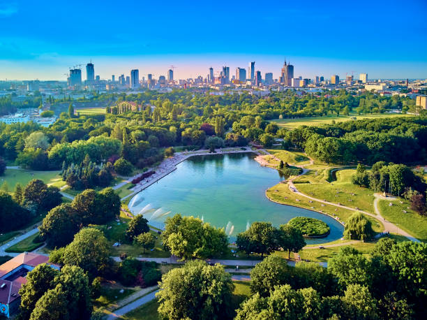 A beautiful panoramic view of the sunset in a fabulous evening in June from drone at Pola Mokotowskie in Warsaw, Poland - "Mokotow Field" is a large park in Warsaw - Is called "Jozef Pilsudski Park" A beautiful panoramic view of the sunset in a fabulous evening in June from drone at Pola Mokotowskie in Warsaw, Poland - "Mokotow Field" is a large park in Warsaw - Is called "Jozef Pilsudski Park" warsaw stock pictures, royalty-free photos & images