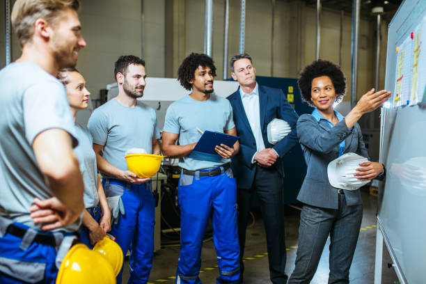 istock Managers and workers having meeting inside of factory 1155396718