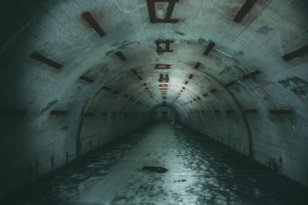 istock Long underground tunnel or corridor in abandoned Soviet military bunker or basement 1155398144