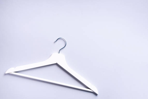istock Top view of white clothes hangers on grey background with copy space. Flat lay. Minimalism style. Creative layout. Fashion, store sale, shopping concept. Banner for feminine blog 1155398270