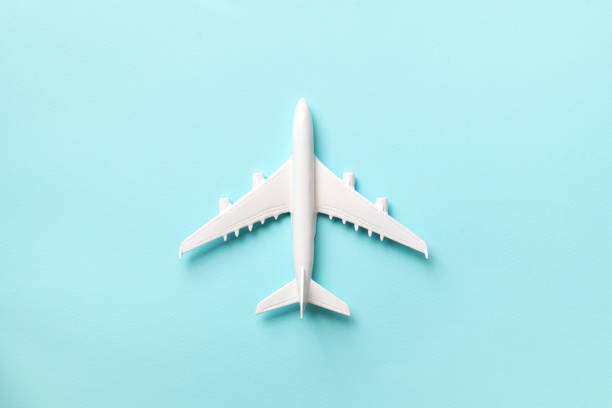 istock Creative layout. Top view of white model plane, airplane toy on pink pastel background. Flat lay with copy space. Trip or travel banner 1155398697