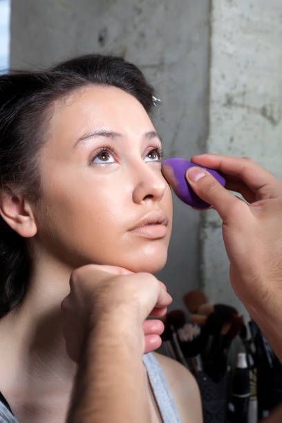 istock makeup artist applied foundation on the face of the client 1155400310