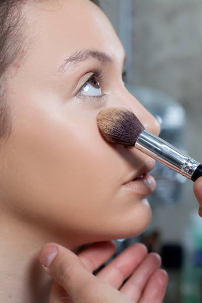 istock makeup artist applied foundation on the face of the client 1155400332