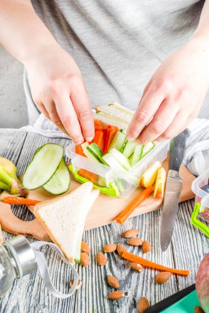 mother preparing school lunch box - child human hand sandwich lunch box imagens e fotografias de stock