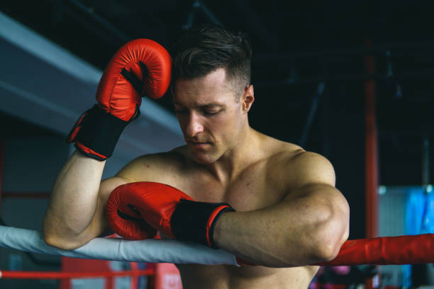 istock Muscular Man Boxing In Gym Before Fighting 1155403528