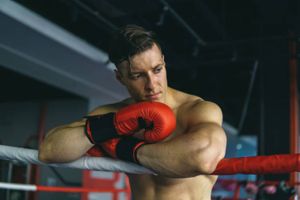 istock Muscular Man Boxing In Gym Before Fighting 1155403541