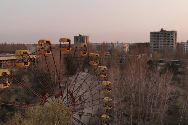 Deserted amusement park in city Pripyat Rusty ferris wheel in the amusement park of the city of Pripyat. Ferris wheel in the City of Pripyat at sunset time. Apocalyptic city of Pripyat after a nuclear explosion at a nuclear power plant. pripyat city stock pictures, royalty-free photos & images