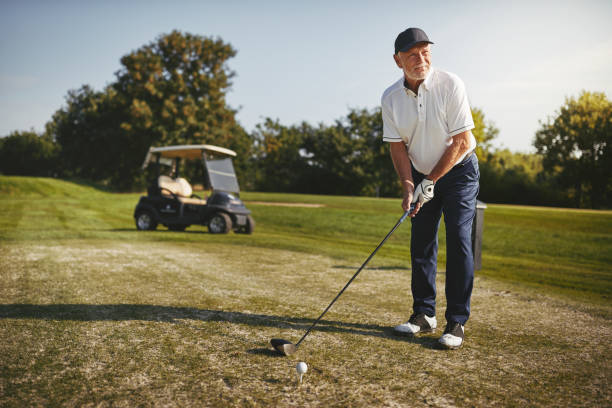 istock Senior man teeing up his shot on a golf course 1155406534
