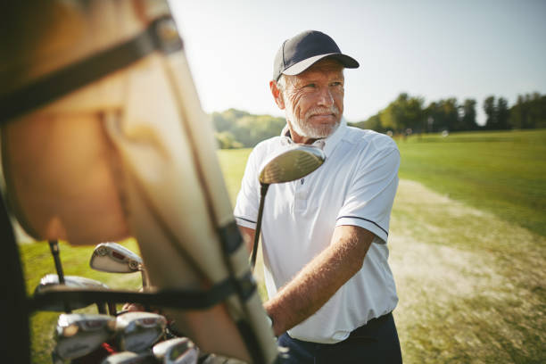 istock Senior man preparing to play golf on a sunny day 1155407213