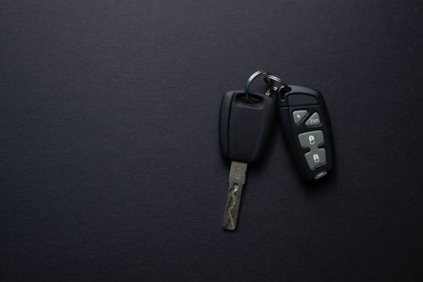 istock Car keys with remote from car alarm on black background 1155407494