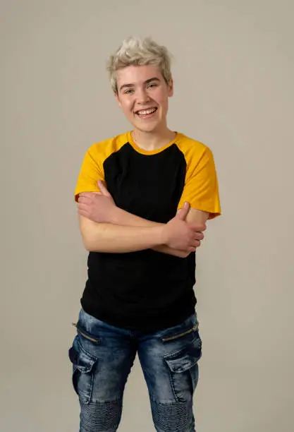 Portrait of attractive stylish fashion teenager confident and happy with his gender identity. Trans boy posing in cool urban fashion t shirt. In Beauty, Transgender people and Equality concept.