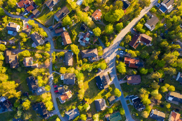 istock Top view, flying over idyllic villa area early morning 1155413223
