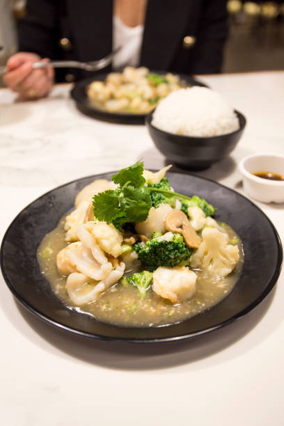 istock Seafood with Broccoli and Cauliflower in garlic sauce 1155413312