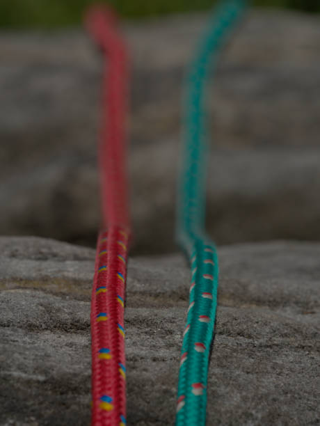 istock Green and orange nylon rope on natural rock background 1155416919