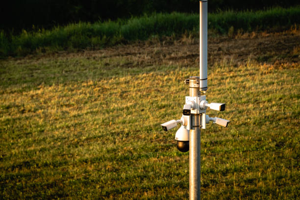 istock CCTV cameras isolated on green meadows. High angle view. 1155417190