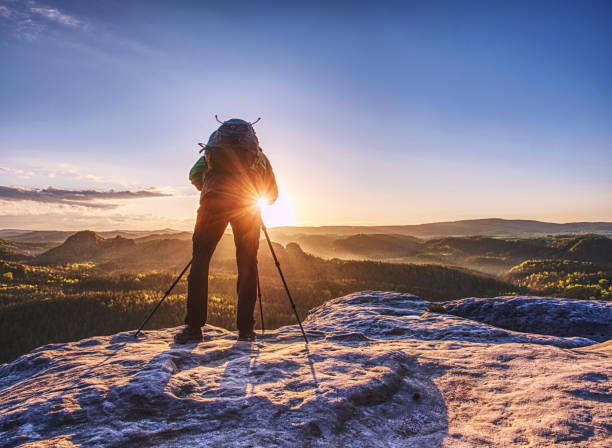 istock Artist holding camera on tripod and pointing with view finder 1155417277