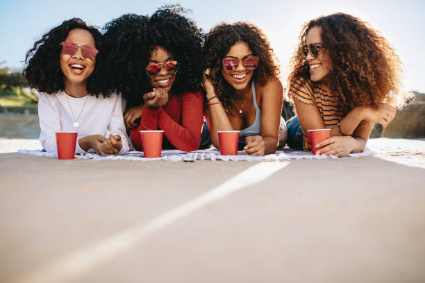 istock Girls enjoying weekend on beach 1155418191