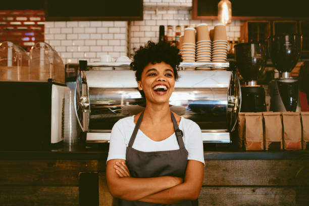 istock Cheerful barista in her coffee shop 1155418406