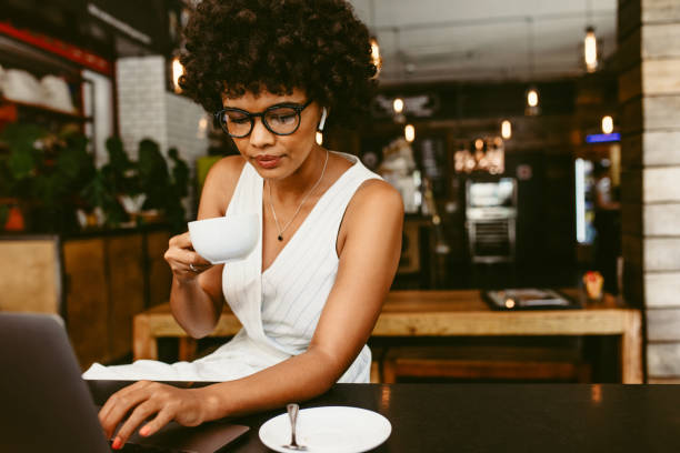 istock Woman sitting in cafe with a laptop 1155418540