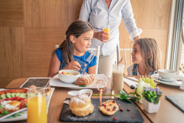 istock grandmother enjoying breakfast with her granddaughters 1155420881