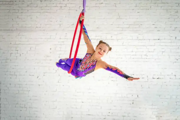 aerial gymnastics on the circle, a little girl doing exercises