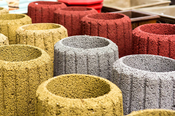 istock stone trash can in an assortment of new multi-colored garbage cans closeup. 1155427629