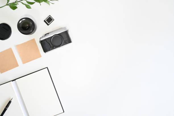 istock Workspace photographer with camera, lens, paper note and pen, Copy space concept. 1155430312
