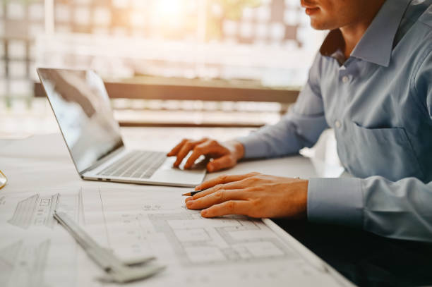 istock Architect design concept. Young engineer drawing of house structure on blueprint to present Customer. Engineering concept. 1155430331