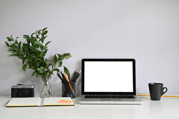 istock Workspace computer laptop and camera with notebook paper with coffee. 1155430386