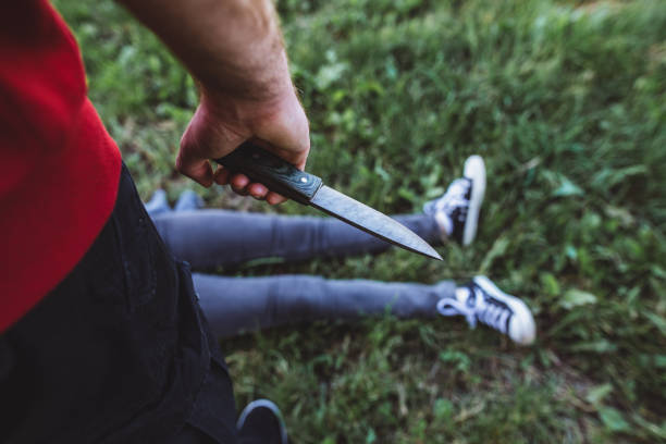 istock Young girl falling prey to a knife murderer 1155432303
