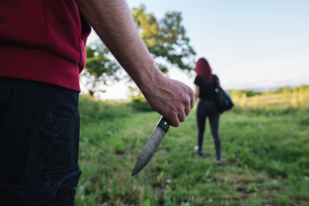 istock Criminal with a dagger following his victim 1155432305