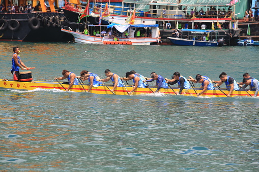 Hong Kong - 2 June 2019: people is in contest on the dragon boat in the dragon boat racing in hong kong for duanwu festival or so call dragon boat festival. the festival commemorates the death of the poet and minister Qu Yuanof the ancient state of Chu during the Warring States period of the Zhou Dynasty