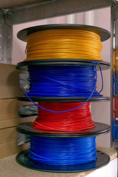 istock 3D printing material, ABS filament, PLA (Polylactic Acid),  PVA Filament.  Colored polymer in coils on the shelves. 1155433246