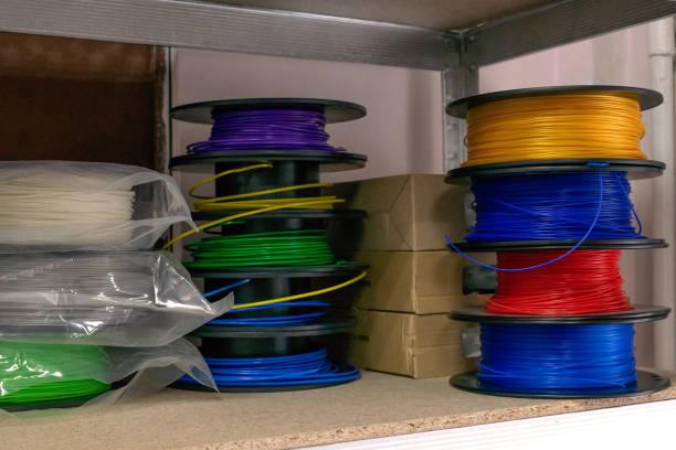 istock 3D printing material, ABS filament, PLA (Polylactic Acid),  PVA Filament.  Colored polymer in coils on the shelves. 1155434019