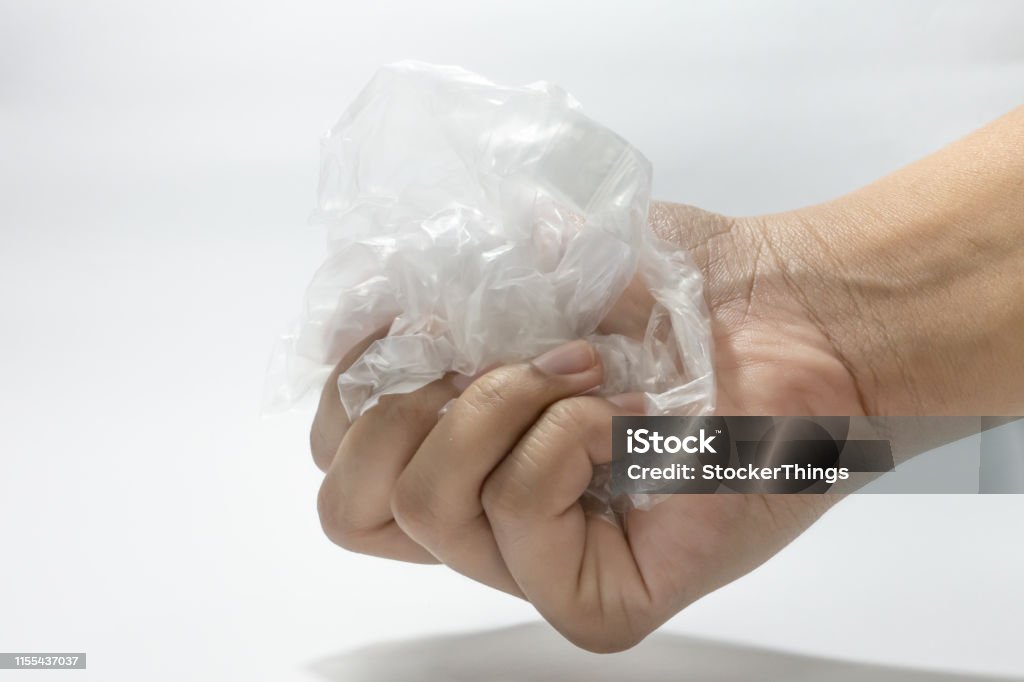 Human hand holding plastic bag on white, concept of say no to plastic bag, eco-friendly Plastic Bag Stock Photo