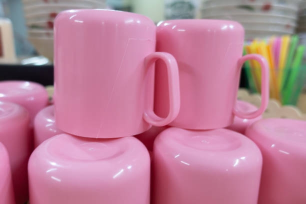 istock Pink plastic cups in the basket ready to use 1155437354