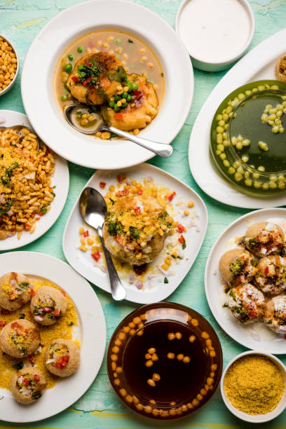 Bombay Chat food in group group of Bombay chat food includes golgappa/panipuri, bhel-puri, sev-poori, dahipuri, Ragda pattice, raj kachori etc. selective focus raj kachori stock pictures, royalty-free photos & images