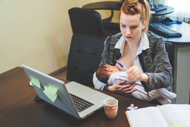 istock Mother working and breastfeed her baby in office 1155442319