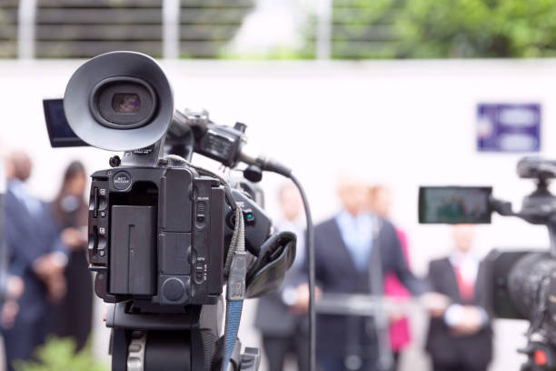 istock Filming news or press conference with a video camera 1155442791