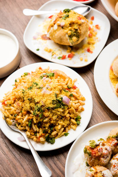 Bombay Chat food in group group of Bombay chat food includes golgappa/panipuri, bhel-puri, sev-poori, dahipuri, Ragda pattice, raj kachori etc. selective focus raj kachori stock pictures, royalty-free photos & images