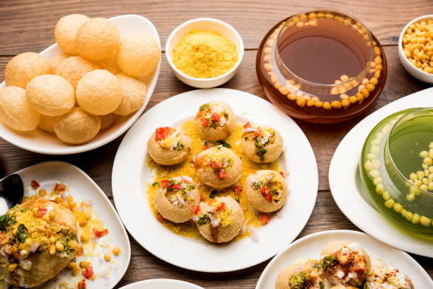 Bombay Chat food in group group of Bombay chat food includes golgappa/panipuri, bhel-puri, sev-poori, dahipuri, Ragda pattice, raj kachori etc. selective focus raj kachori stock pictures, royalty-free photos & images